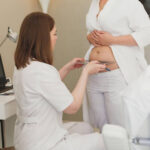 A doctor consulting a patient who is in a consult for abdominoplasty in Sydney